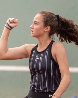 Patricia Grigoras raising a fist after winning a point